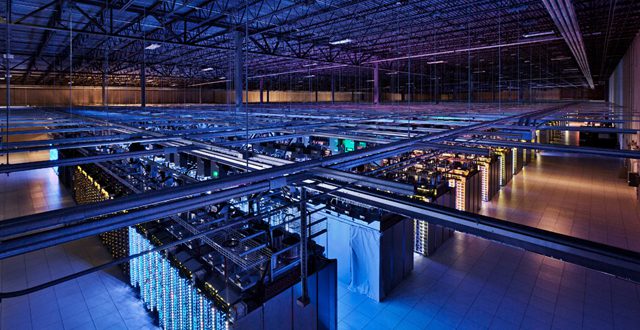 Racks filled with servers line a data center.