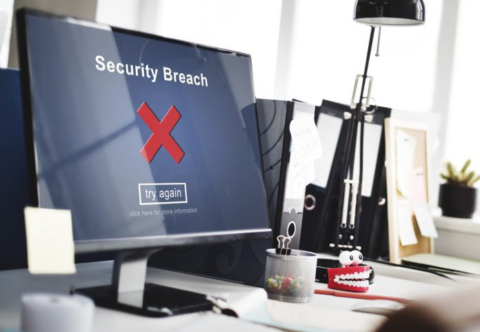 A computer monitor alerts a user to a security breach.